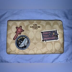 Coach Beige Wristlet with Decorative Patches. Cinderella